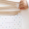Wooden sticks with motivational phrases next to a polka dot notebook with 'Mindful & Co' branding.