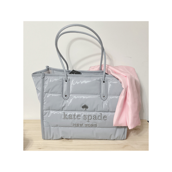 Introducing the Kate Spade Ella Puffy Extra Large - the perfect bag that fits EVERYTHING! The stunning Brushed Steel color is perfect for all seasons, versatile and stylish choice.  Details:  Measurements:  15.4" W x 12.32" H x 8.8" D Strap Drop: 4.72" Handle Drop: 12.0" Closure Type: drop in top zip closure Interior: back pocket Materials polyester Trim: pebbled leather trim Dust Bag included: Yes Style#: K9488 New With Tages