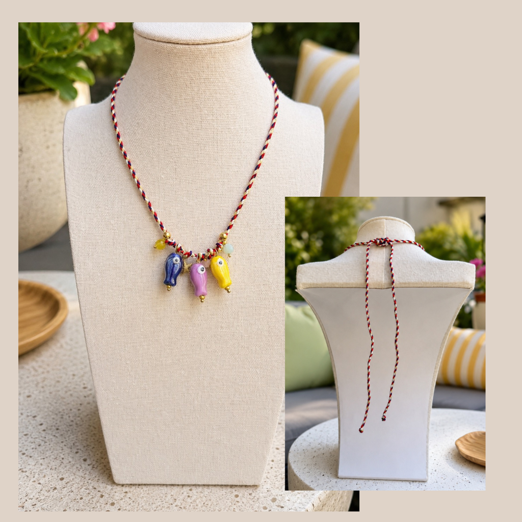 Necklace with colorful fish ceramic beads on a mannequin bust.