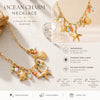 Ocean charm necklace with gold plating and various charms on a neutral background