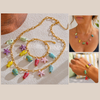 Colorful necklace with fish and starfish charms on a textured surface, worn by a person.