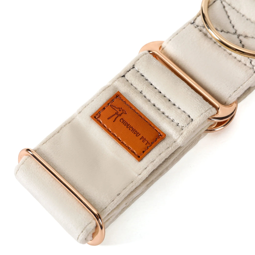 Dog collar with rose gold hardware and a leather tag on a white background