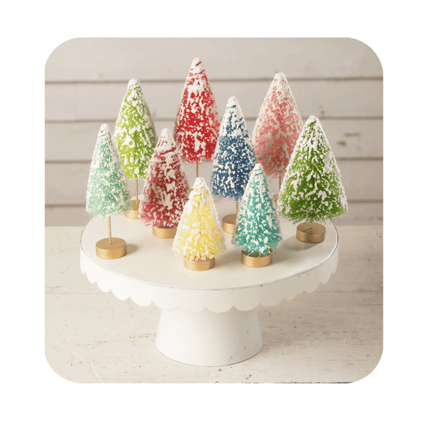 Bethany Lowe Bottle Brush Tree Set of 9 - Add a pop of color to your holiday decorations with these playful colorful bottle brush trees! This set of 9 whimsical trees includes a variety of vibrant hues and features gold-painted bases for an extra touch of magic. The snowy accents add a touch of enchantment, as if these trees came straight from a Christmas wonderland!