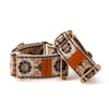 Dog collar with floral pattern and brown leather strap on a white background
