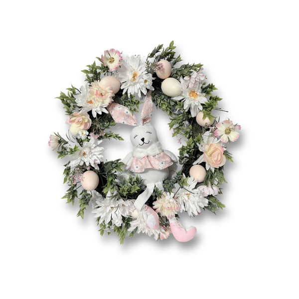 Easter floral and plush bunny wreath.  This adorable Easter bunny front door wreath will welcome your family and friends in a sunshine way or add some charm to your spring wall decor. This spring flower wreath features a sweet Easter bunny girl with dangling legs sitting among flowers, greenery, and easter eggs.