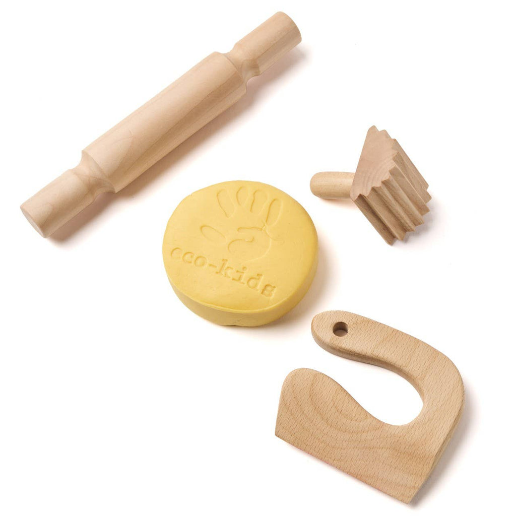Set of wooden kitchen tools including a rolling pin, yellow stamp, and other shapes on a white background.