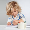 Child drawing with colorful markers on a white surface; Great stocking stuffer ideas for toddlers