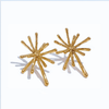 Gold starburst earrings on a white background