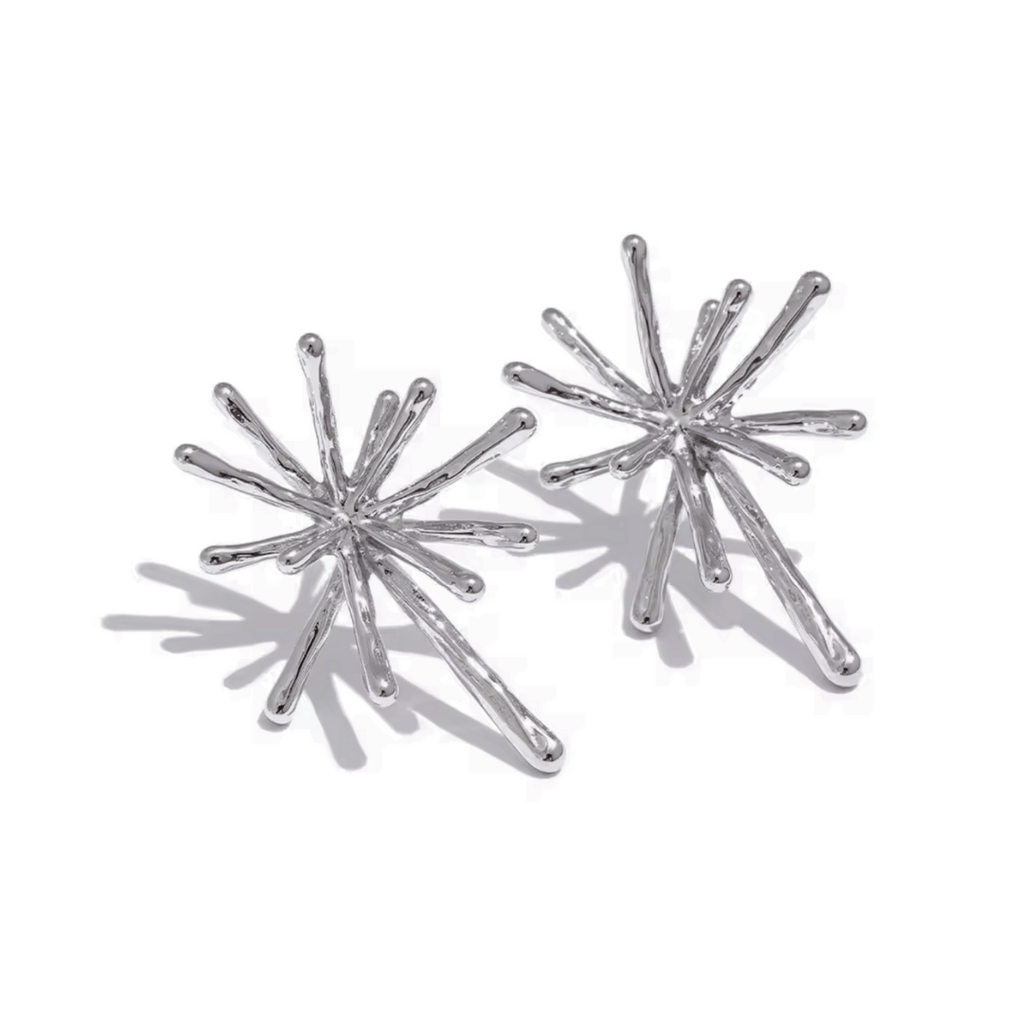 Silver starburst earrings on a white background