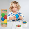 Child playing with eco-dough next to packaging and containers on a white background