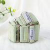 Green checkered dog collar with metal buckle on a white background