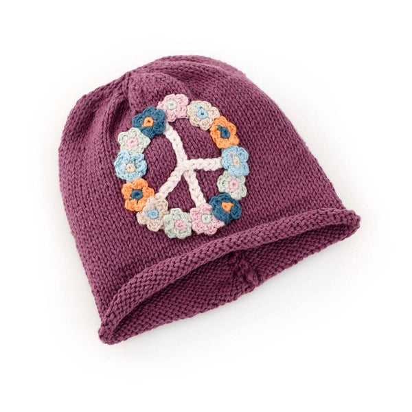 Knitted hat with a peace sign made of flowers on a white background