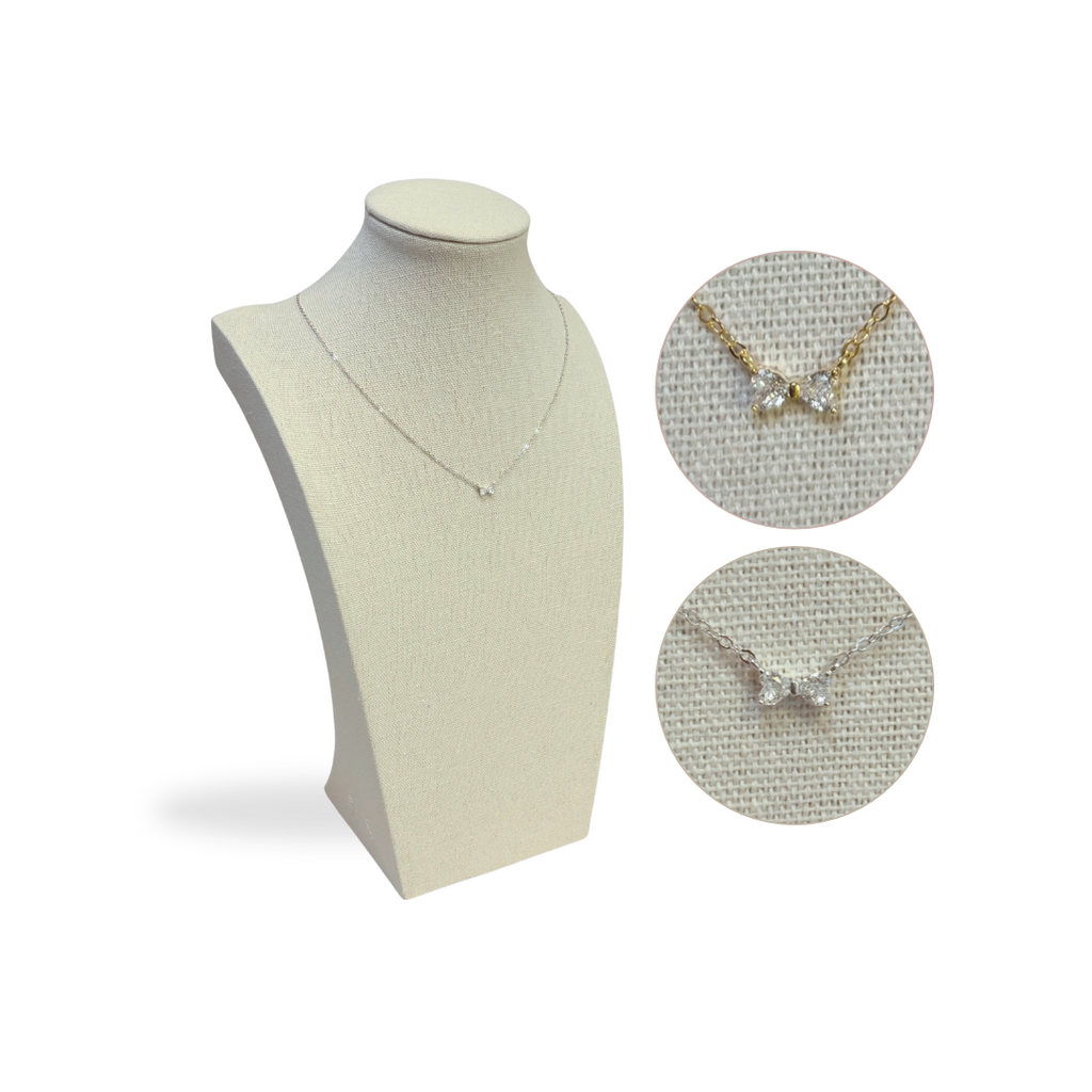 diamond bow Necklace displayed on a mannequin bust with close-up insets on a white background