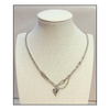 Silver necklace with a heart pendant on a paperclip chain on a mannequin bust.