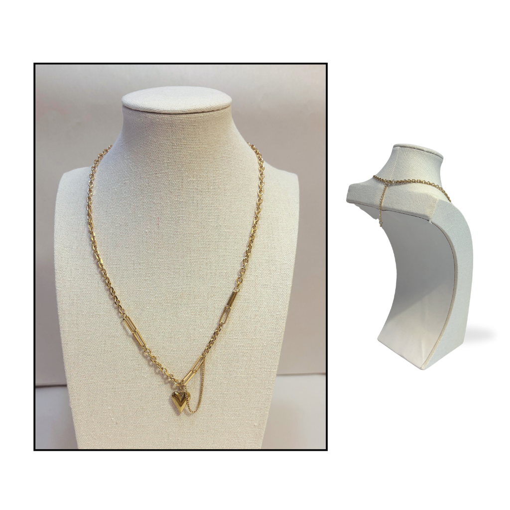 Gold puffy heart paperclip and chain necklace longer style on a mannequin bust with a plain background