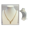 Gold necklace with heart pendant on a mannequin bust against a white background