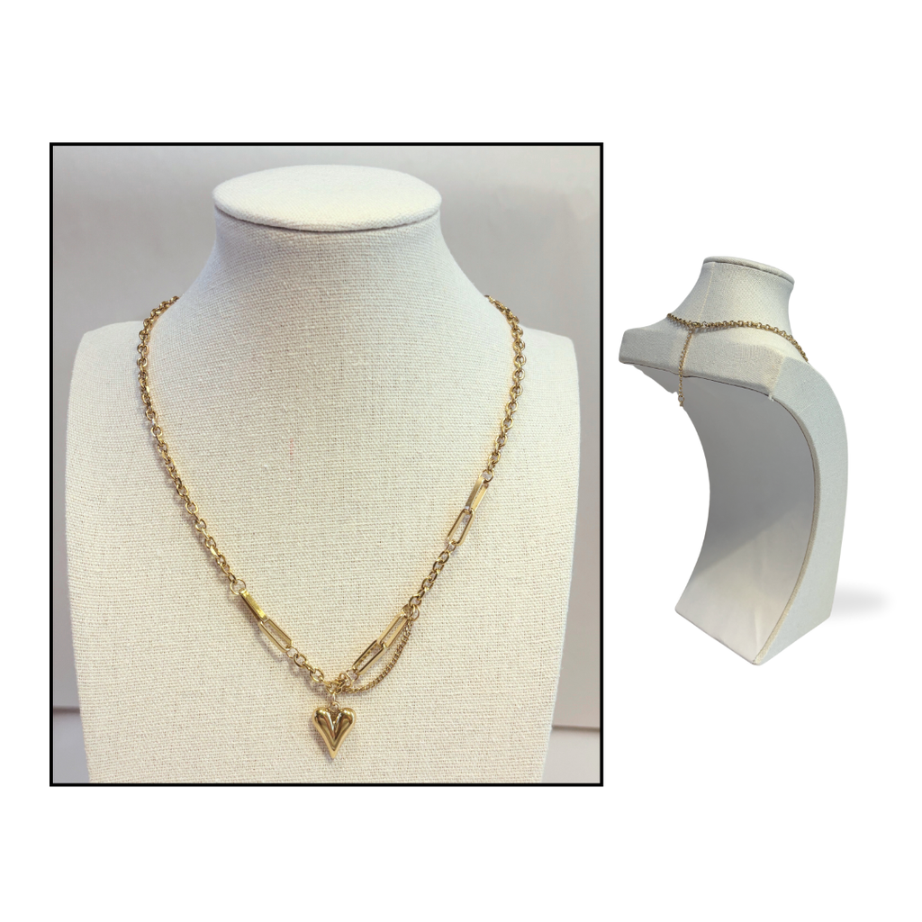 Gold necklace with heart pendant on a mannequin bust against a white background