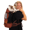 Woman holding a dog in a red backpack with 'K9 Gear' branding on a transparent background