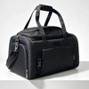 A black pet carrier duffel bag with dual top handles, a detachable shoulder strap, and textured mesh side panels, photographed on a clean white studio background.