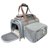 A gray mesh pet carrier bag with brown handles, shown open with a pet bed inside and a separate zippered pouch attached to the side, on a plain white background.