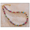 Colorful beaded necklace on a textured beige surface