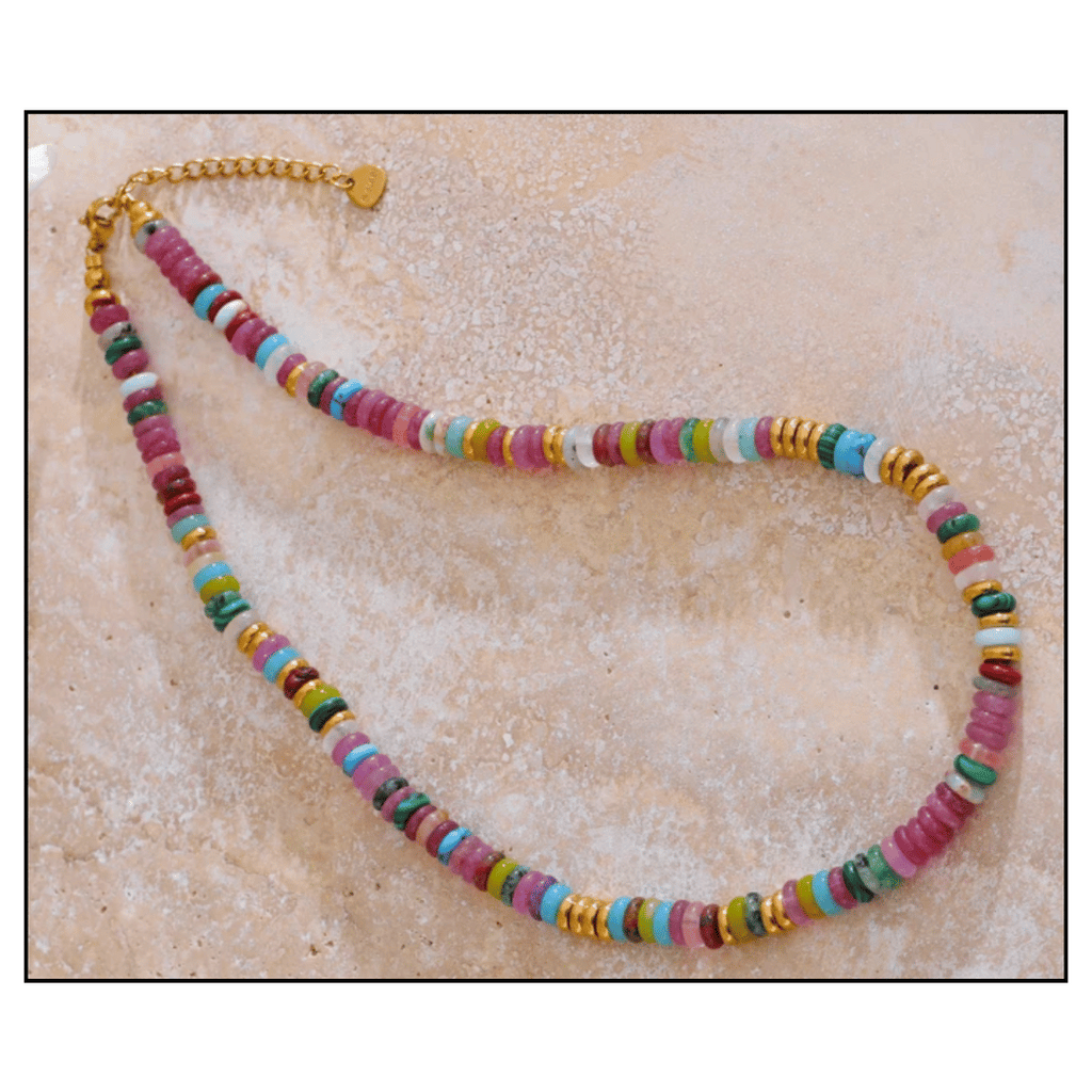 Colorful beaded necklace on a textured beige surface