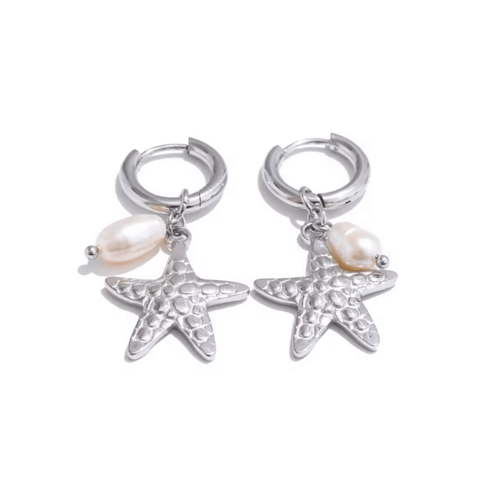 Pair of silver hoop earrings with starfish and pearl charms on a white background