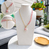 Necklace with pink beads and pearls on a mannequin bust with close-up insets, outdoor setting.