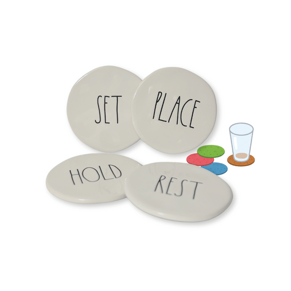 Rae Dunn Ceramic Coasters Stoneware CoastersEnhance your drink experience with these ceramic coasters featuring beautifully engraved words "Rest", "Place", "Set", and "Hold" in charming Rae Dunn artisan lettering. Each coaster measures 3.75" in diameter, adding a touch of elegance to your coffee mugs or any other beverage. Don't settle for ordinary coasters, elevate your home decor with this lovely set.