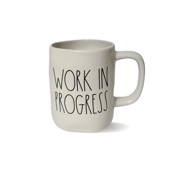 Experience motivation and encouragement with this ceramic mug, showcasing Rae Dunn's iconic "Work in Progress" design. Let the uplifting message and elegant aesthetic inspire your journey ahead.&nbsp;