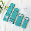 Set of teal checkered dog collars with metal buckles on a white surface.