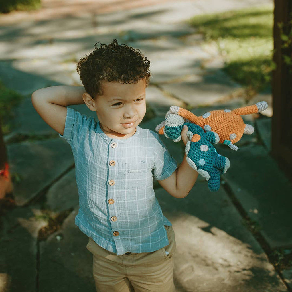 Child holding a toy in an outdoor setting