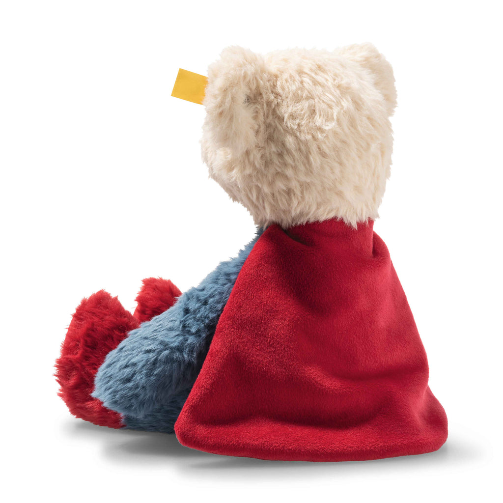 STeiff Plush toy with a red blanket draped over it on a white background