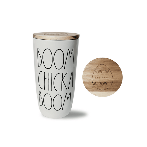 <p>Experience the charm and artisanship of the Rae Dunn x Magenta Stoneware Wood Top Canister, adorned with the playful phrase "Boom Chicka Boom." Add a touch of energy to your kitchen this spring and Easter with this stylish and inspiring piece. Material: StonewareEngraved Lettering 8"Tall x 4.25" Diameter Style: Farmhouse, Contemporary