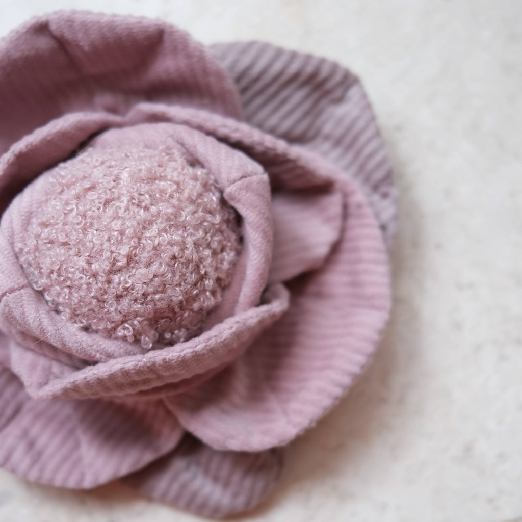 Pink textured flower-shaped object on a light background dog boredom toy