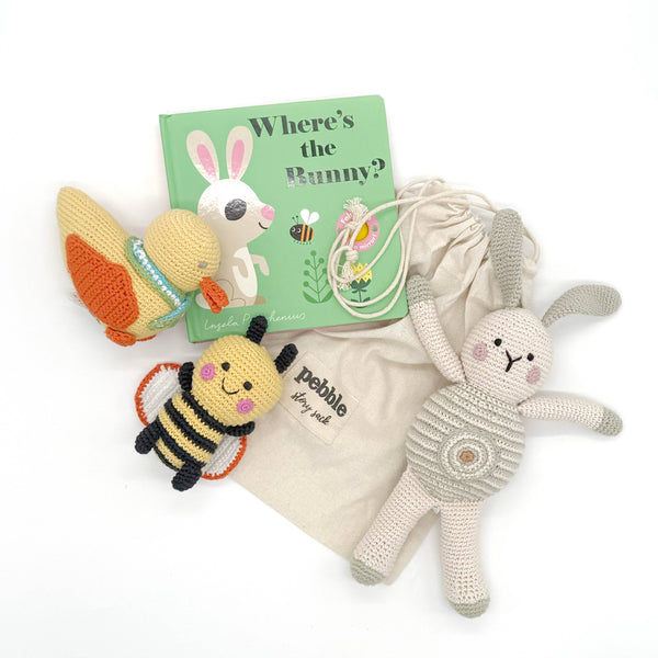 Set of fair trade organic toys including a bunny, butterfly, and bee, with a book titled 'Where's the Bunny?' on a white background.