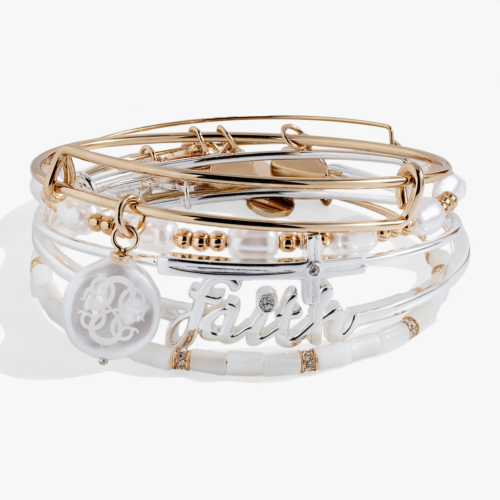 Set of gold, silver, and clear bangles on a white background